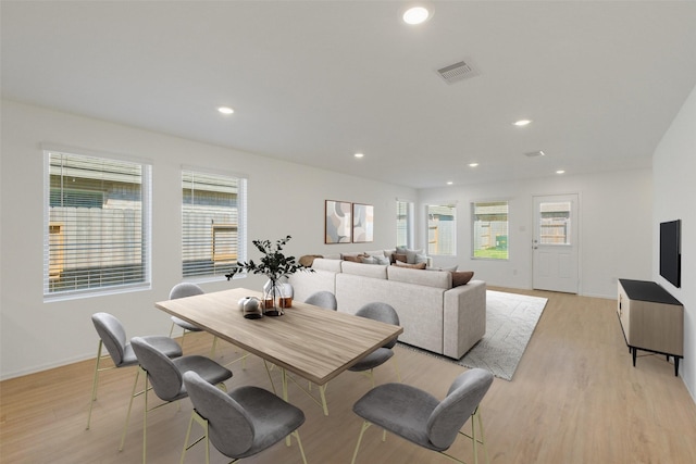 dining room with recessed lighting, light wood-style flooring, baseboards, and a healthy amount of sunlight