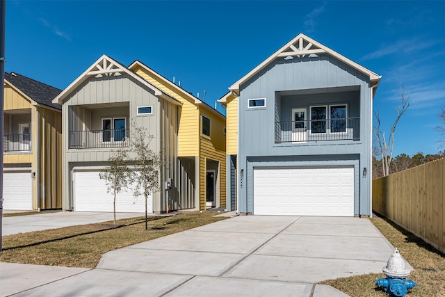 view of front of property with board and batten siding, an attached garage, and driveway