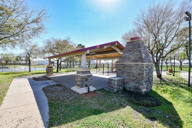 view of community featuring a gazebo, a lawn, and fence