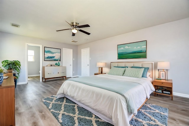 bedroom featuring visible vents, baseboards, a ceiling fan, and light wood finished floors