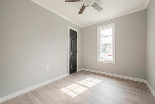 empty room with ceiling fan, baseboards, light wood-style flooring, and crown molding