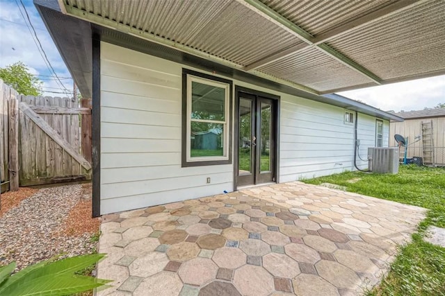 view of patio / terrace featuring central AC unit and fence