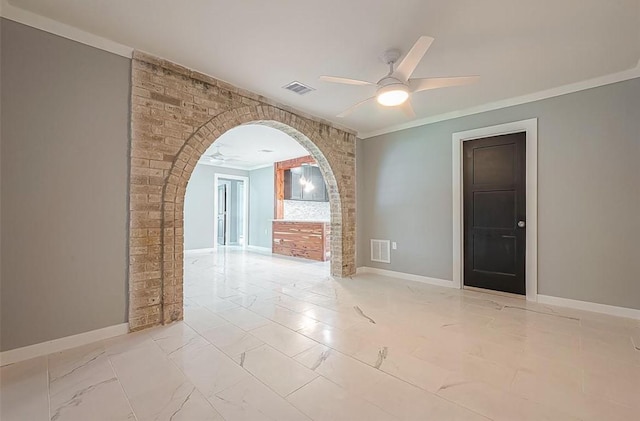 empty room featuring arched walkways, visible vents, and a ceiling fan