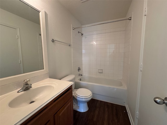 bathroom with shower / bathtub combination, toilet, wood finished floors, and vanity