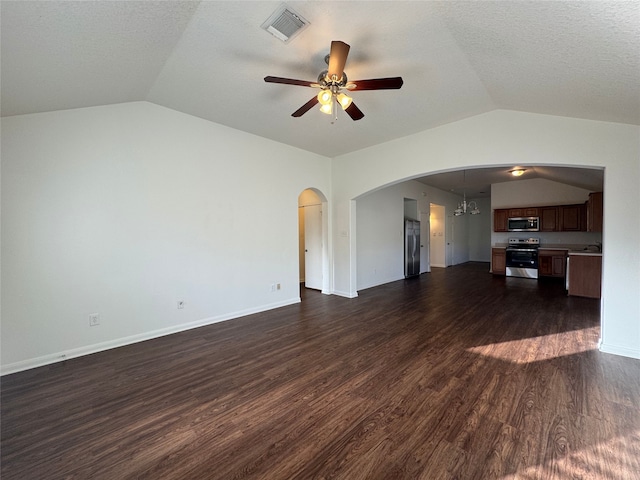 unfurnished living room with dark wood finished floors, visible vents, arched walkways, and vaulted ceiling