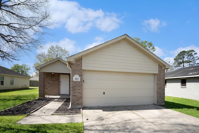 view of front facade with a garage, a front yard, brick siding, and driveway