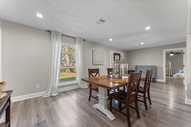 dining space featuring visible vents, baseboards, recessed lighting, wood finished floors, and a textured ceiling