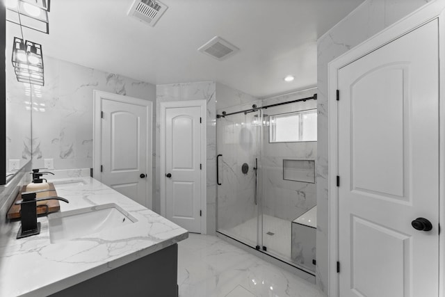 bathroom featuring a sink, visible vents, a marble finish shower, and marble finish floor