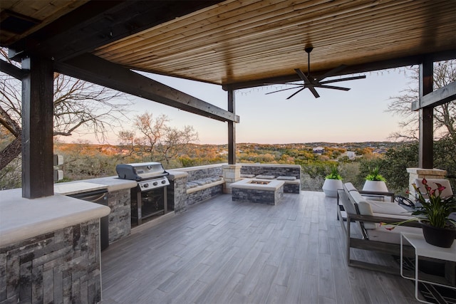 359 Cambridge Dr, New Braunfels, TX 78132 - patio terrace at dusk with a fire pit, a ceiling fan, and exterior kitchen