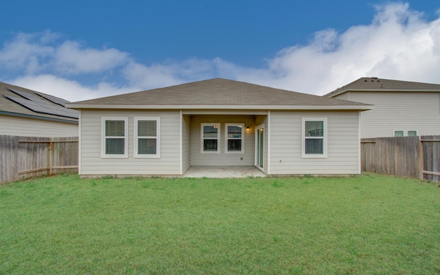 back of property featuring a patio, a yard, and a fenced backyard