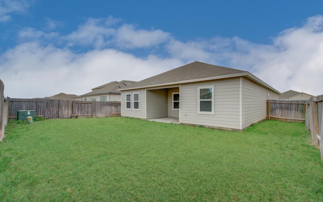 back of house with a yard, a patio, and a fenced backyard