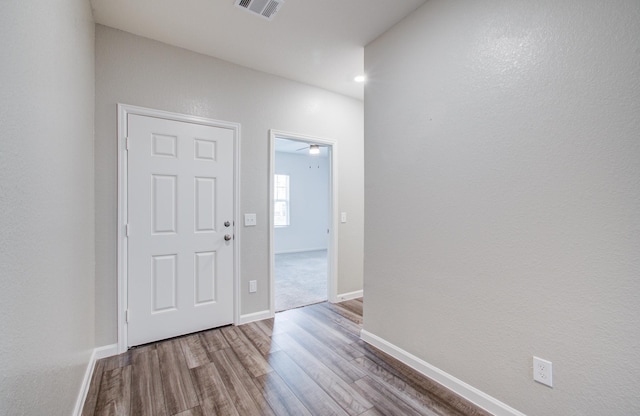 entrance foyer featuring wood finished floors, visible vents, and baseboards