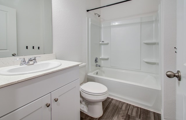 full bathroom with bathtub / shower combination, toilet, wood finished floors, and vanity