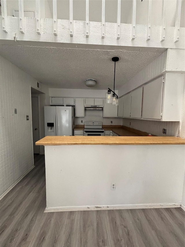 kitchen featuring range with electric cooktop, dark wood-type flooring, under cabinet range hood, refrigerator with ice dispenser, and butcher block counters