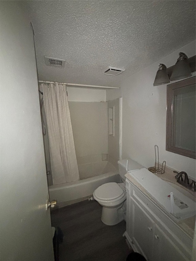 full bathroom featuring vanity, visible vents, a textured ceiling, toilet, and shower / tub combo with curtain