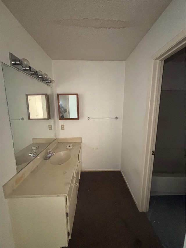 bathroom with a textured ceiling and vanity