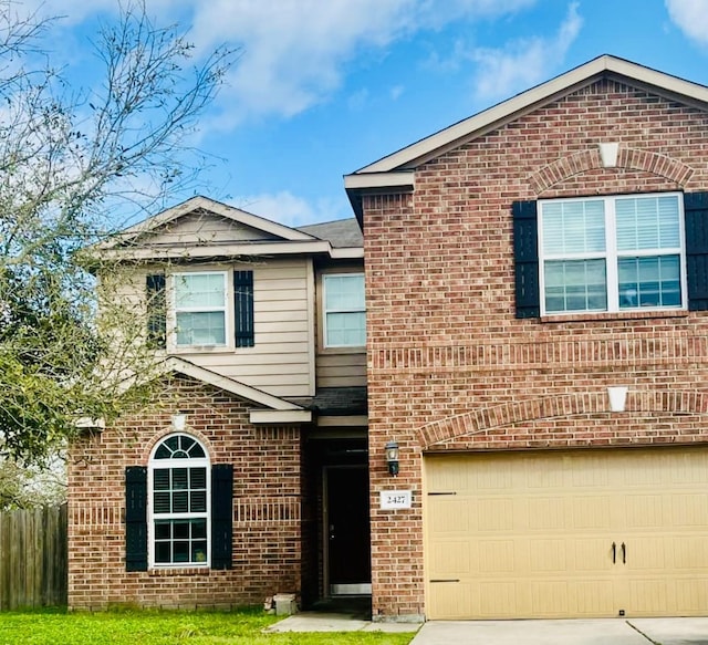 view of front of home featuring an attached garage, fence, brick siding, and driveway