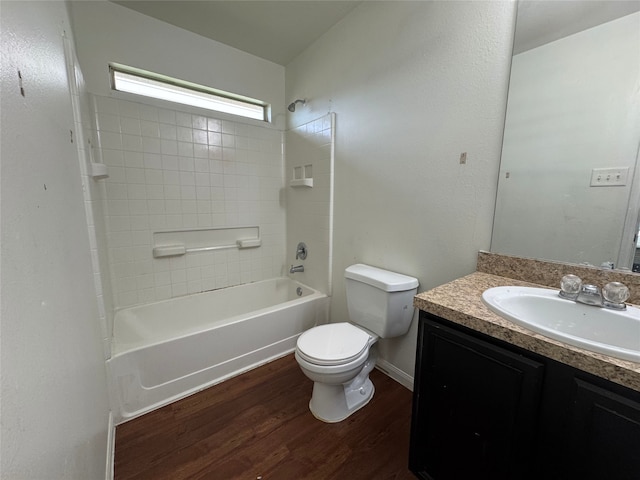 bathroom featuring shower / bathtub combination, toilet, vanity, and wood finished floors