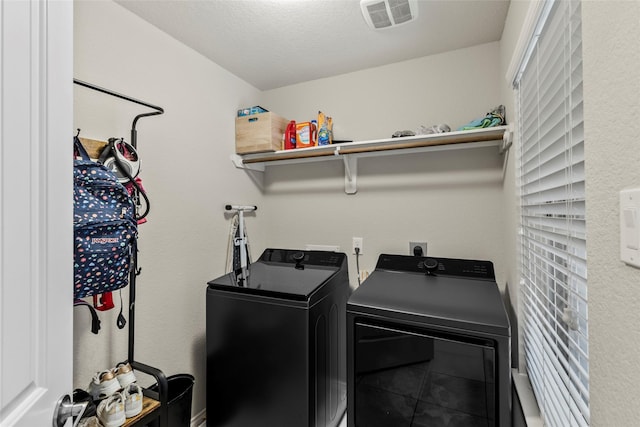 laundry area with washing machine and clothes dryer, laundry area, and visible vents