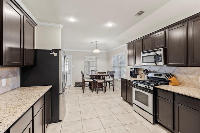 kitchen featuring visible vents, ornamental molding, appliances with stainless steel finishes, light tile patterned floors, and dark brown cabinets