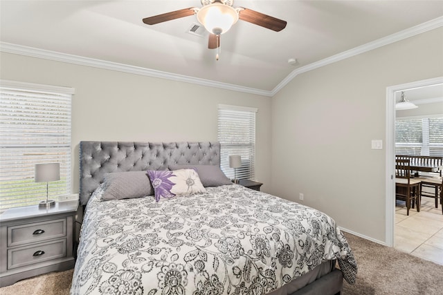 carpeted bedroom featuring tile patterned floors, lofted ceiling, ornamental molding, a ceiling fan, and baseboards