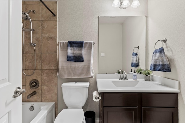 full bathroom with shower / bath combination, toilet, vanity, and a textured wall