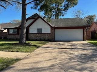 single story home with a garage and concrete driveway