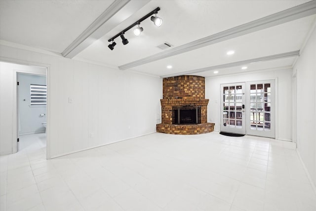 unfurnished living room featuring visible vents, beam ceiling, track lighting, recessed lighting, and a fireplace