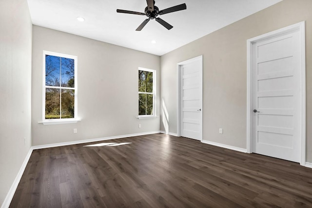 unfurnished bedroom with recessed lighting, baseboards, and dark wood-type flooring