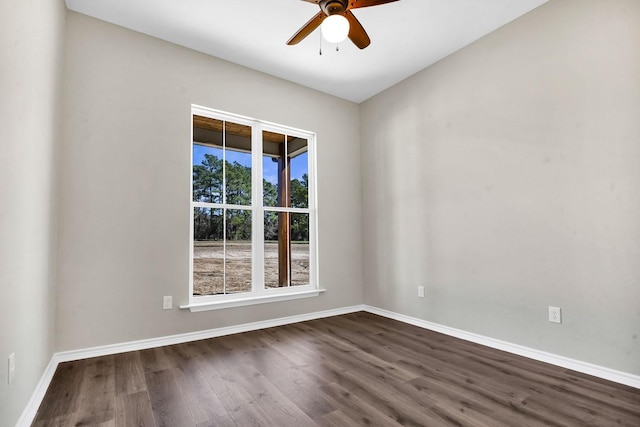 unfurnished room featuring baseboards, a ceiling fan, and dark wood-style flooring