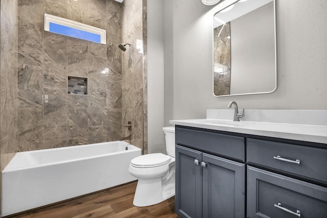 bathroom featuring bathtub / shower combination, toilet, wood finished floors, and vanity