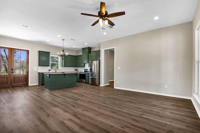 kitchen featuring visible vents, green cabinetry, light countertops, stainless steel appliances, and dark wood-style flooring