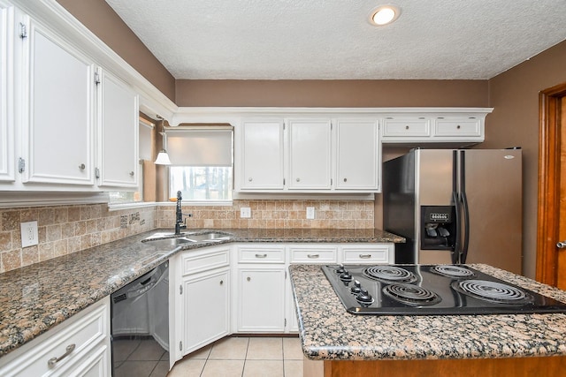 kitchen with a sink, black appliances, white cabinets, and a center island