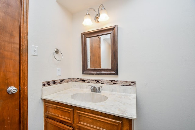 bathroom featuring tasteful backsplash and vanity