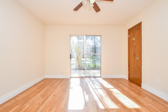 empty room featuring light wood-type flooring, baseboards, and a ceiling fan