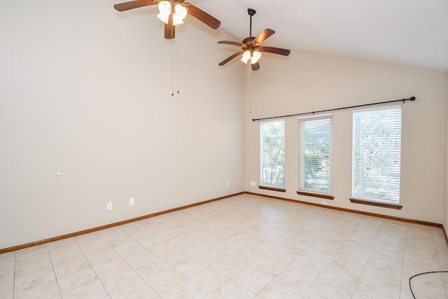 spare room with baseboards and high vaulted ceiling