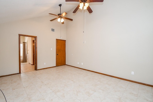 empty room featuring visible vents, baseboards, and high vaulted ceiling