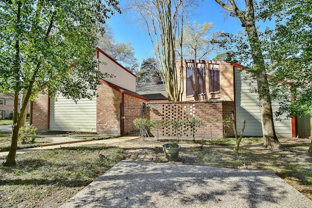 exterior space featuring brick siding