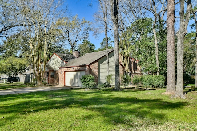 view of home's exterior featuring driveway, an attached garage, a chimney, a lawn, and brick siding