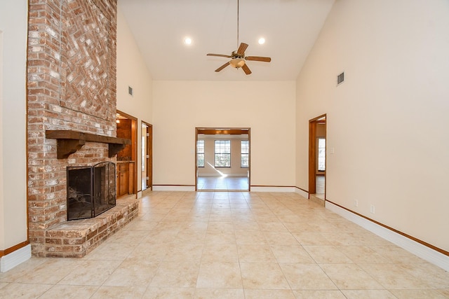 unfurnished living room with tile patterned floors, visible vents, a brick fireplace, and baseboards