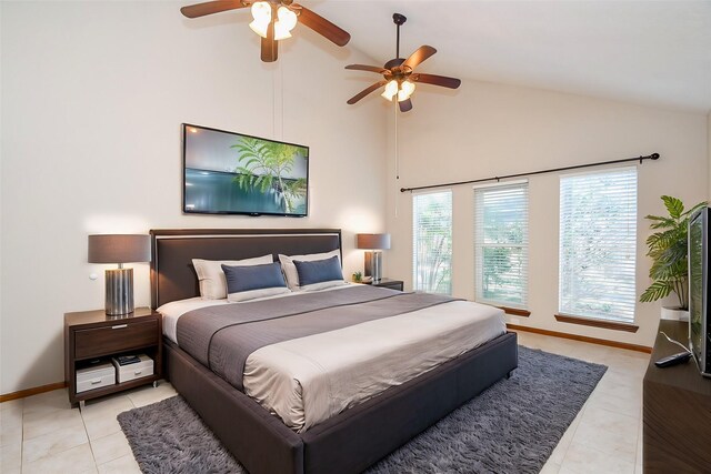 bedroom with light tile patterned floors, baseboards, high vaulted ceiling, and a ceiling fan