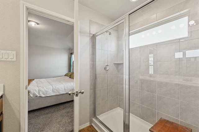 bathroom with vanity, a shower stall, and connected bathroom