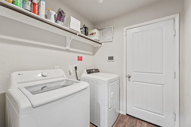 laundry room featuring laundry area, dark wood-style floors, and washing machine and clothes dryer