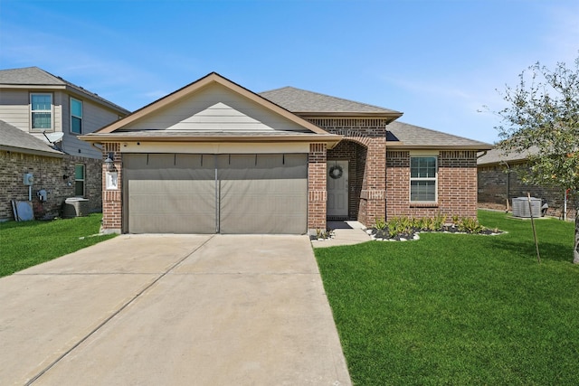 ranch-style home featuring brick siding, concrete driveway, a front yard, central AC unit, and an attached garage