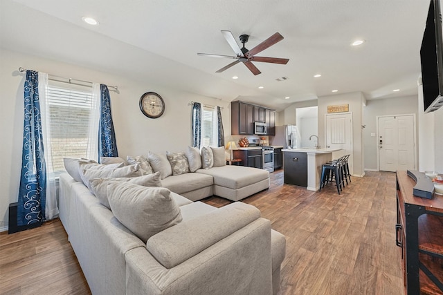 living area featuring recessed lighting, light wood-style flooring, visible vents, and ceiling fan