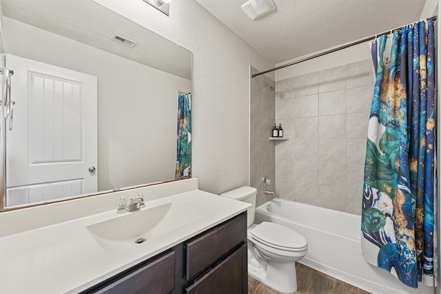 full bathroom with visible vents, toilet, shower / bath combo, a textured ceiling, and wood finished floors