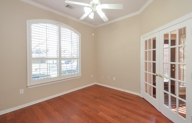 unfurnished room with wood finished floors, crown molding, french doors, and visible vents