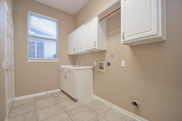 washroom with washer hookup, cabinet space, light tile patterned floors, baseboards, and hookup for an electric dryer