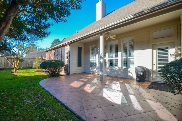 view of patio featuring area for grilling, a ceiling fan, and fence