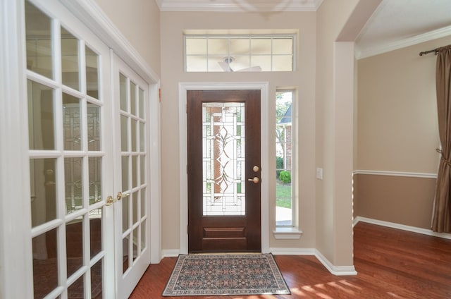 foyer entrance featuring french doors, baseboards, wood finished floors, and ornamental molding